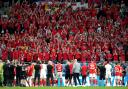 Wales players applaud the travelling supporters following their World Cup exit