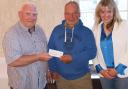 Councillor Keith Evans receives the cheque on behalf of Glangwili hospital from Keith Evenden and Teresa Brunt.