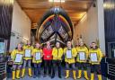 RNLI's Director of Lifeboat Operations John Payne presenting New Quay RNLI six crew members with their awards and Lifeboat Operations Manager Roger Couch
