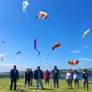 Councillor Clive Davies, of Ceredigion County Council, Lyn Jenkins of Cardigan Island Coastal Farm Park, Paul and Helene Morgan, of Sky Bums Kite Designers of Shropshire, and other kite enthusiasts.