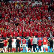 Wales players applaud the travelling supporters following their World Cup exit