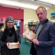 Author Mike Lewis presented copies to Tracey Johnson, Manager of Fishguard Library.