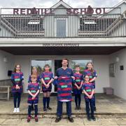 Specsavers Haverfordwest director Andy Britton and Redhill pupils are pictured with the new kit.
