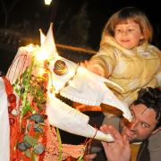 This delighted youngster meets the Mari Lwyd.