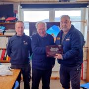 Bernie Davies (L) and Daniel Potter (R) receiving the plaque from a Stourbridge RNLI fundraiser