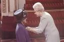 Mary Bott receives her MBE from her late Majesty, the Queen.