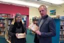 Author Mike Lewis presented copies to Tracey Johnson, Manager of Fishguard Library.