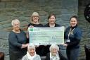 The group of fundraisers from Llanon with the cheque for Bronglais Chemo Appeal. Picture: Hywel Dda Health Charities