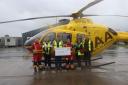 Calfyn Jones hands over a cheque for £4,500 to the Wales Air Ambulance crew.