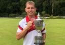 Cardigan bowler Kevin James with the trophy.
