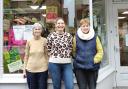 Cardigan Oxfam Shop manager Lizzy Bailey is pictured between two of the volunteers, Philippa and Jo, outside the shop.