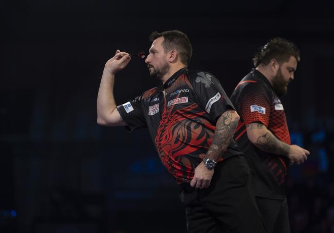 Jonny clayton on the World Championship stage against Michael Smith. Pic: Lawrence Lustig / PDC