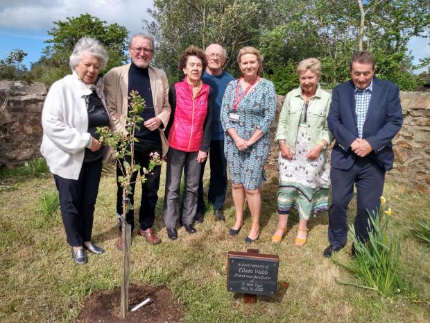 Tivyside Advertiser: Representatives of Yr Hen Ysgol and Wales Air Ambulance with an apple tree planted in Eileen's memory