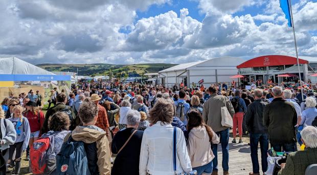 Tivyside Advertiser: A large crowd congregated outside the Welsh Government's stand on the Eisteddfod maes as part of Cymdeithas yr Iaith's rally calling for a Property Act (Image: Twitter/Cymdeithas yr Iaith).