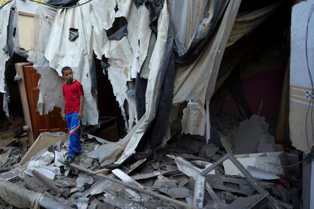 Mohammad Arada looks at the rubble of his family house after it was destroyed by an Israeli airstrike, in Rafah refugee camp, southern Gaza Strip
