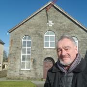 Cllr Cris Tomos  pictured outside Brynmyrnach  Chapel which locals plan to buy on behalf of the community.