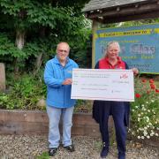 Tim Hill presents the £700 cheque to Helen Pruett of Wales Air Ambulance