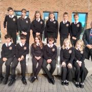 Ysgol Bro Gwaun's record Year 7 intake of six sets of twins , pictured with head teacher Paul Edwards. Picture: Western Telegraph