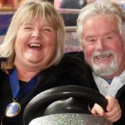 In the driving seat: Deputy Mayor Sian Maehrlein - who officially opened the Fair at lunchtime - wrestles the dodgem wheel from husband and consort David. PICTURE: Stuart Ladd.