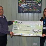Ken Symonds presents a cheque of £3500 to Paige Denyer on behalf of the Chemo unit at Glangwili Hospital