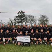 Crymych Rugby Club with the James family and the cheque for £30,000