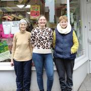 Cardigan Oxfam Shop manager Lizzy Bailey is pictured between two of the volunteers, Philippa and Jo, outside the shop.