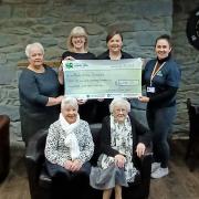 The group of fundraisers from Llanon with the cheque for Bronglais Chemo Appeal. Picture: Hywel Dda Health Charities