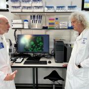 Sir Brian May in discussion with Professor Glyn Hewinson at the Aberystwyth University labs.