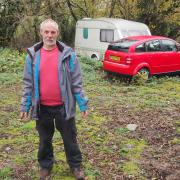I shall not be moved: ‘Land pirate’ Neil Parker is pictured on the contested plot of land off the A487 at Tremain.