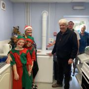 Mike Harwood and community co-ordinator Nic King with volunteers at the recent Christmas fair in Canolfan Dyffryn.