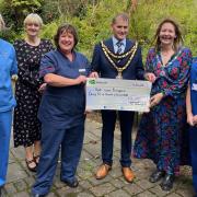 Cllr Maldwyn Lewis presenting the funds to staff at the chemotherapy day unit