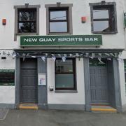 A woman has admitted two offences at New Quay Sports Club.