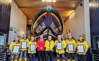 RNLI's Director of Lifeboat Operations John Payne presenting New Quay RNLI six crew members with their awards and Lifeboat Operations Manager Roger Couch